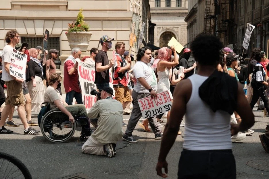 A group of people marching at a Philadelphia rally against genocide in Palestine