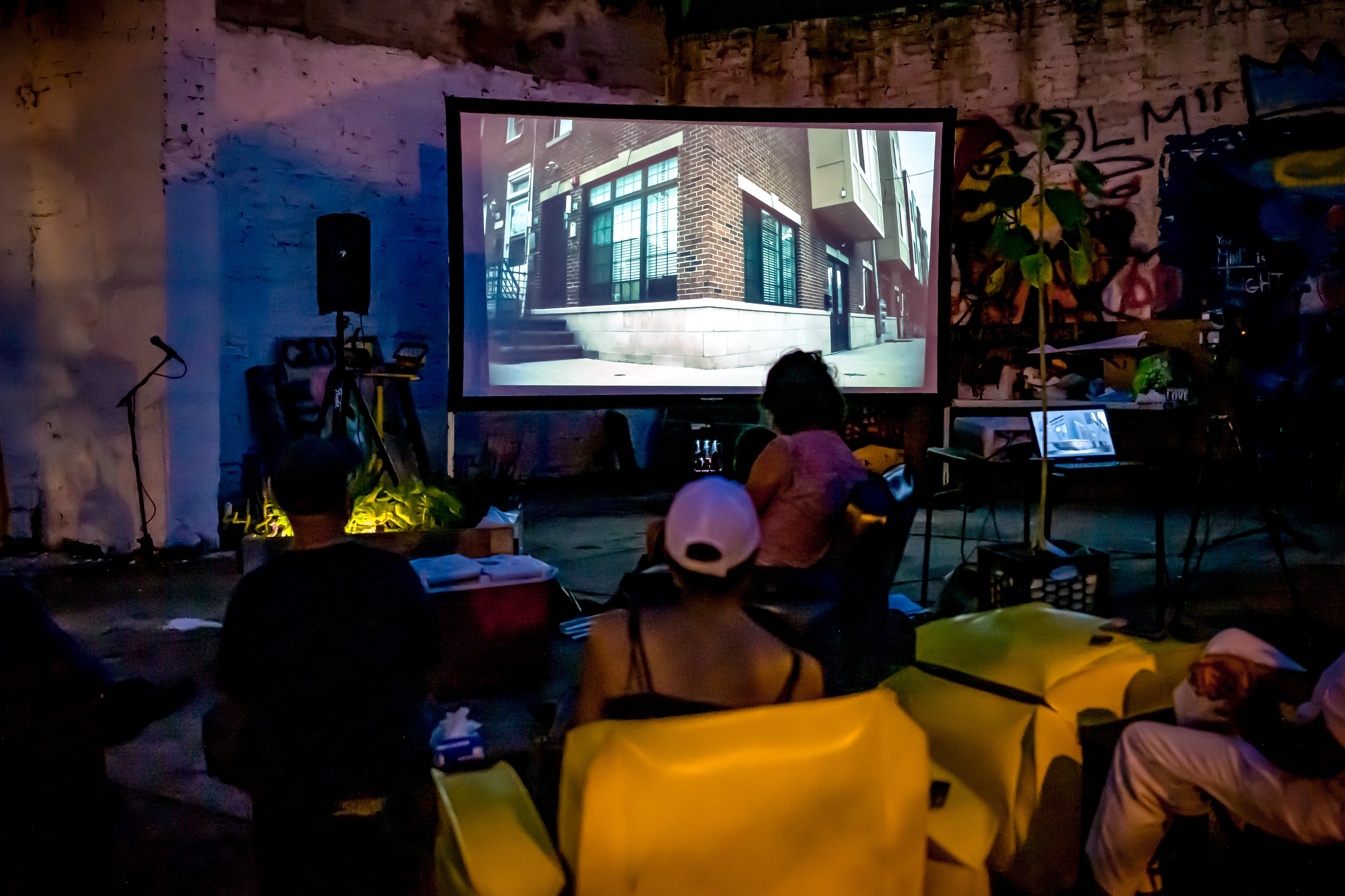 people watching a screen at street film festivals