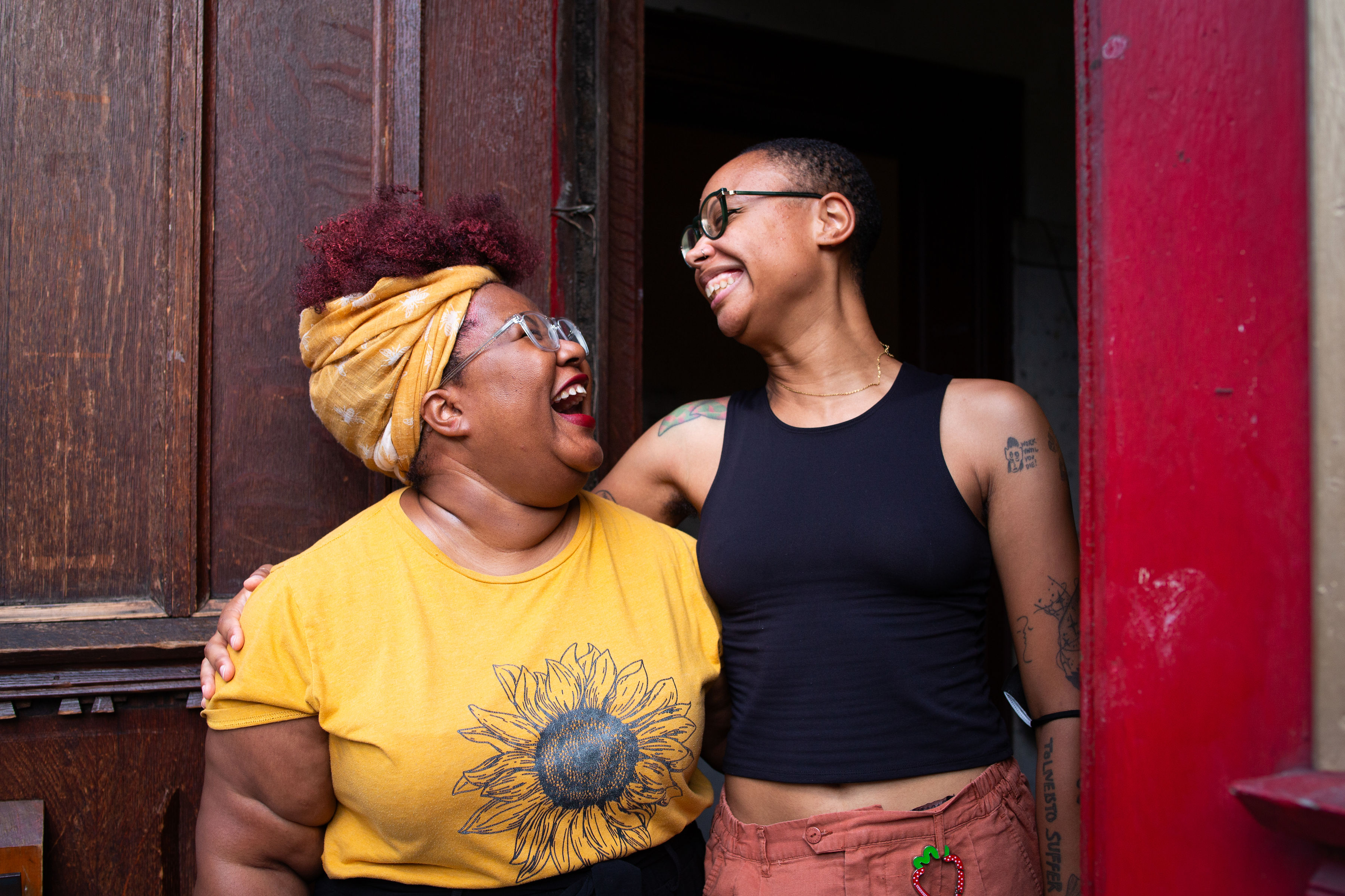 two people smiling at each other while in a side embrace