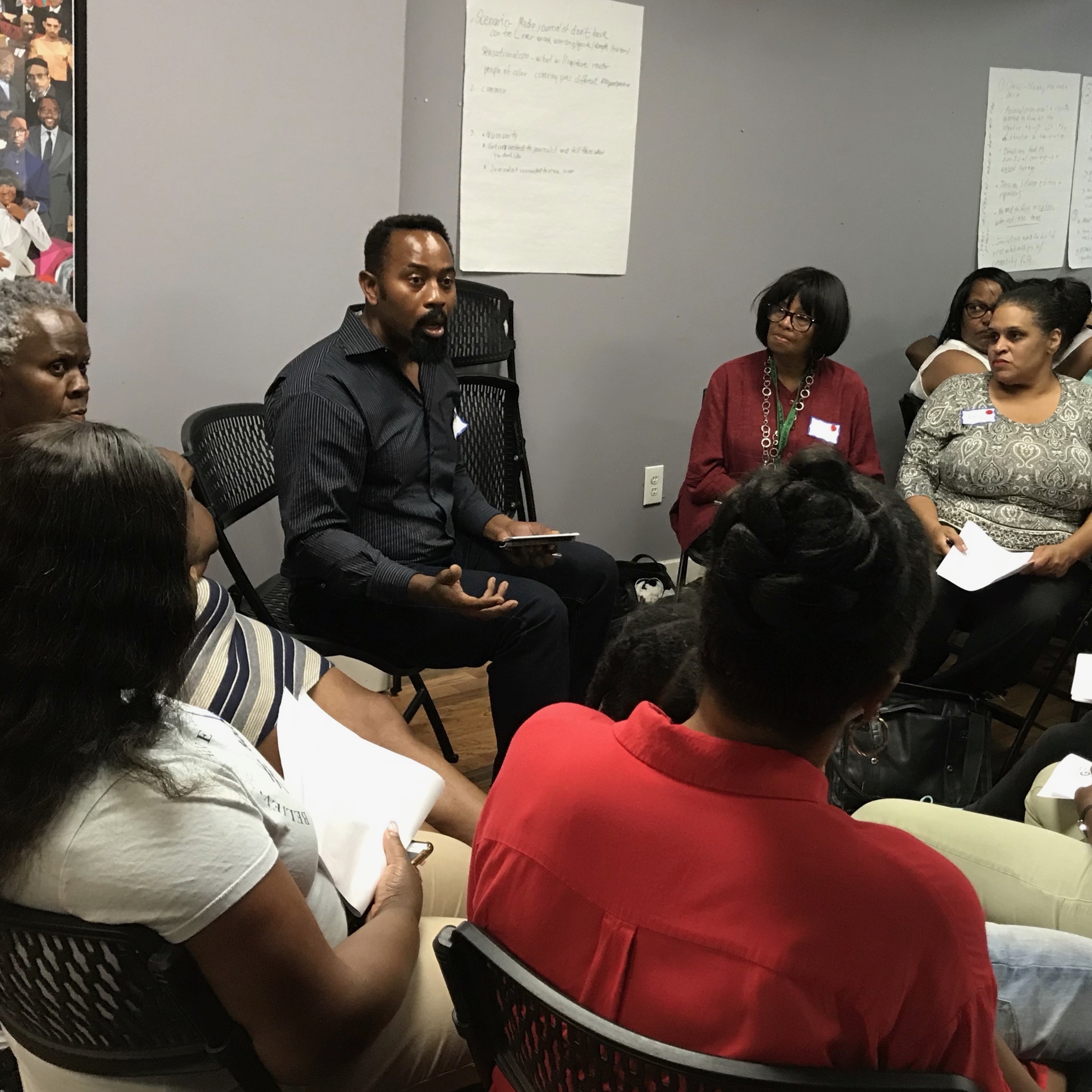 a group of people sitting in a circle and talking