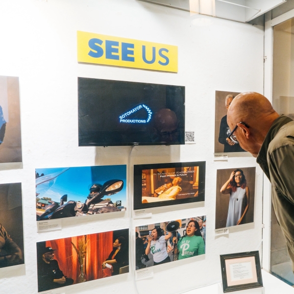 A man looking at a media exhibit in Philadelphia's City Hall