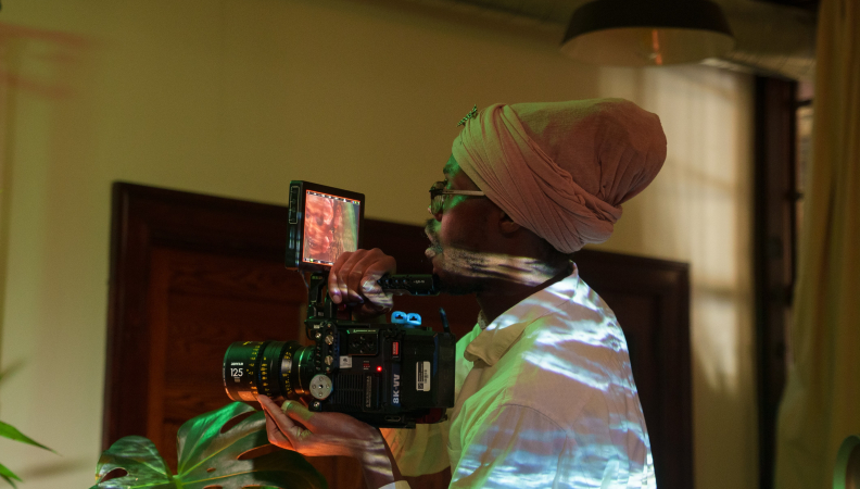 a person holding a film camera while shooting a scene