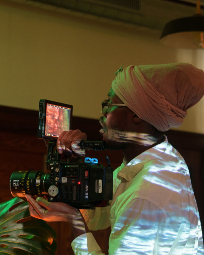 a person holding a film camera while shooting a scene