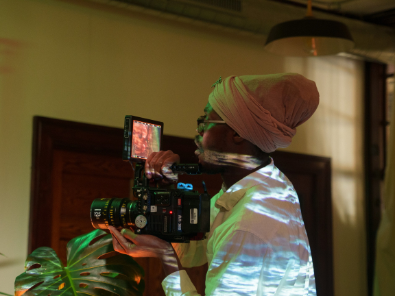a person holding a film camera while shooting a scene