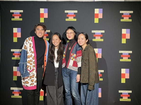four people pose at a philadelphia asian american film foundation event