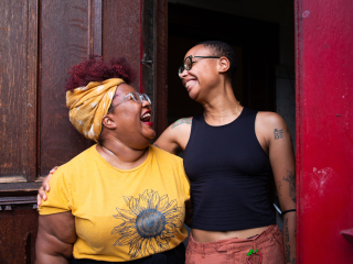 two people in a side embracing smiling at each other